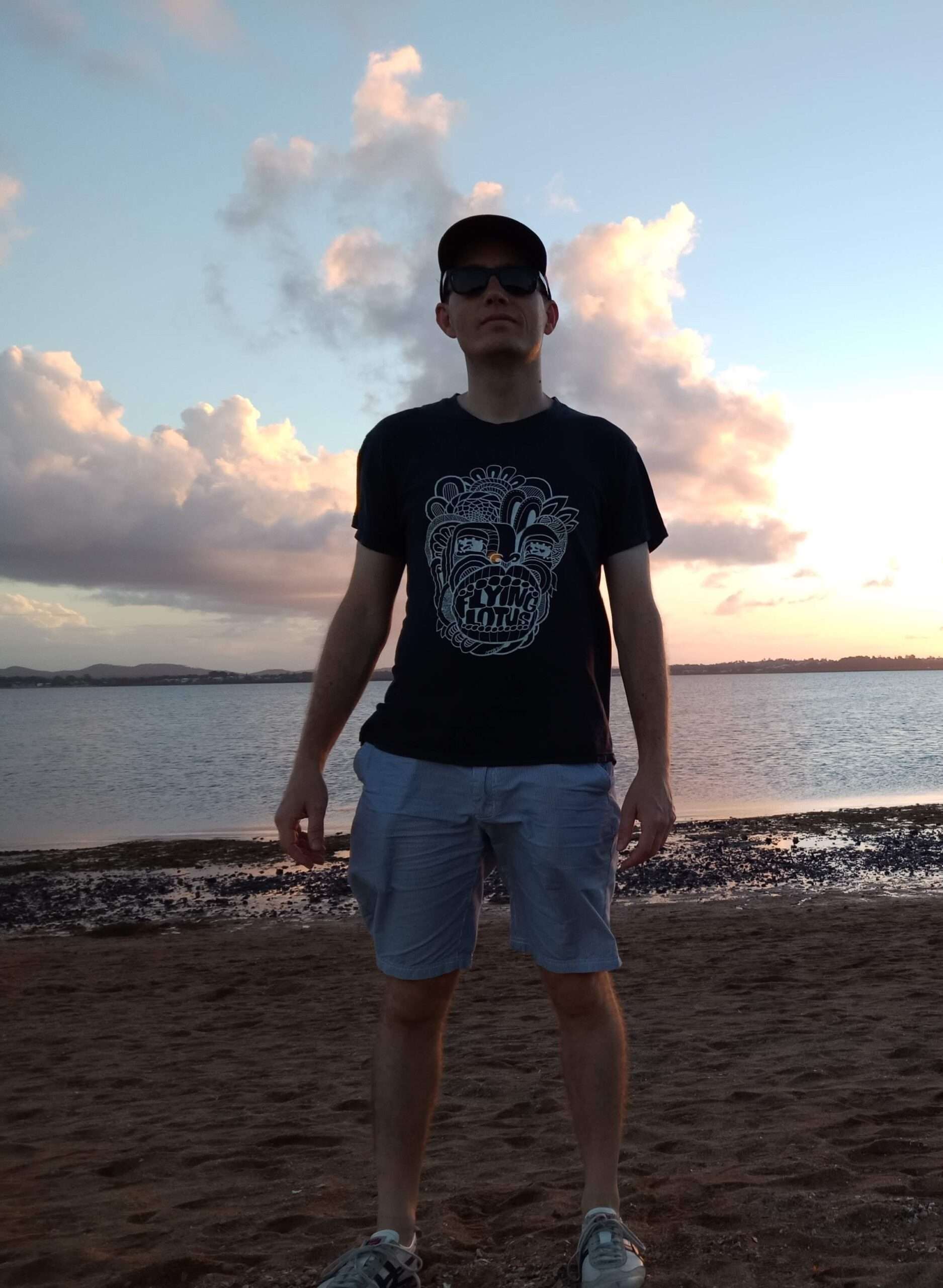 Me, looking towards the viewer, at a beach at sunset
